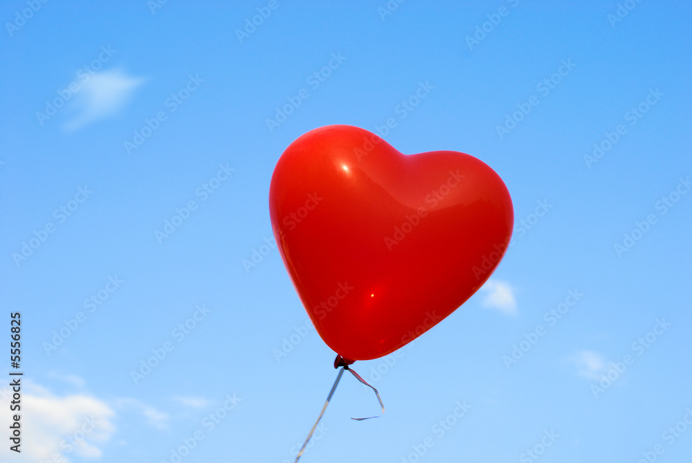Red heart-shaped ballon with blue sky