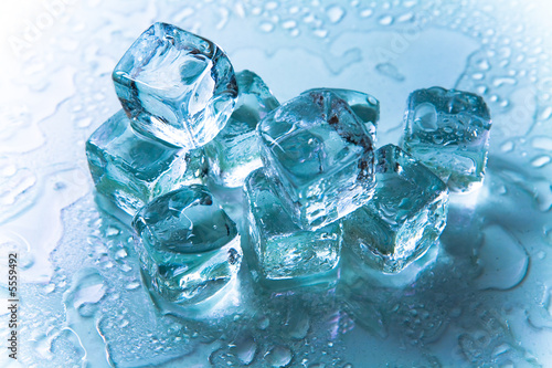 Melting ice cubes on reflective background