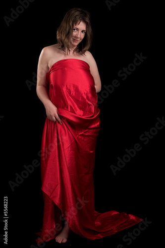 Young woman in red clothes on the black background