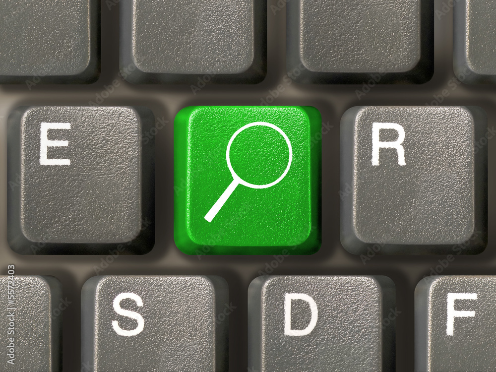 Computer keyboard, key with magnifier, close-up Computer keyboard, key with magnifier, close-up