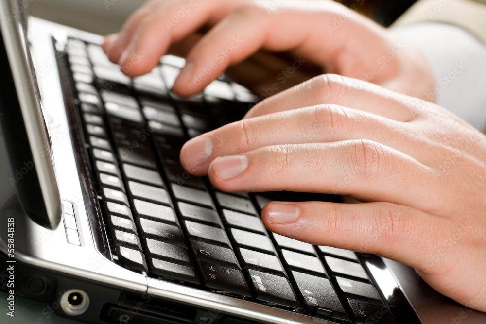 Image of male hands typing a letter on the laptop Image of male hands typing a letter on the laptop