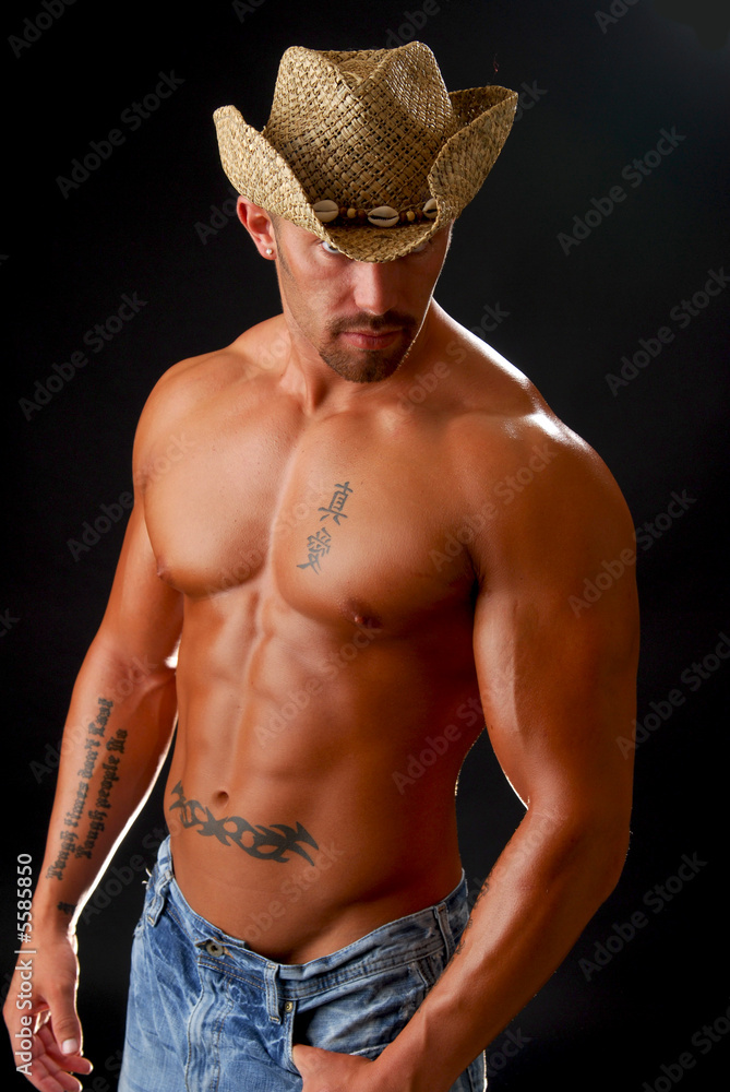 A muscular man in a cowboy hat