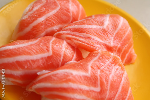 A plate of raw salmon sushi