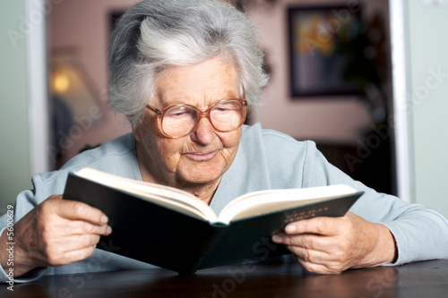 Elderly woman reading a book