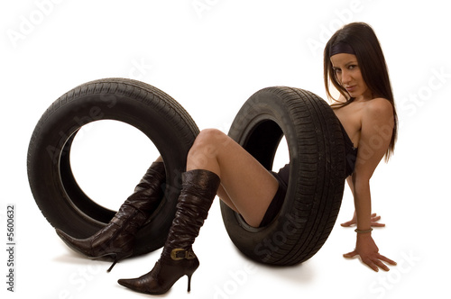 Young sexy girl with a car wheel
