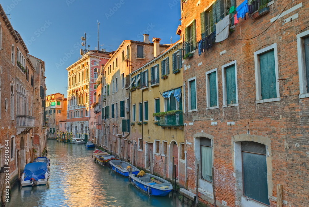 Typical canal in Venice, Italy with boats and nice weather