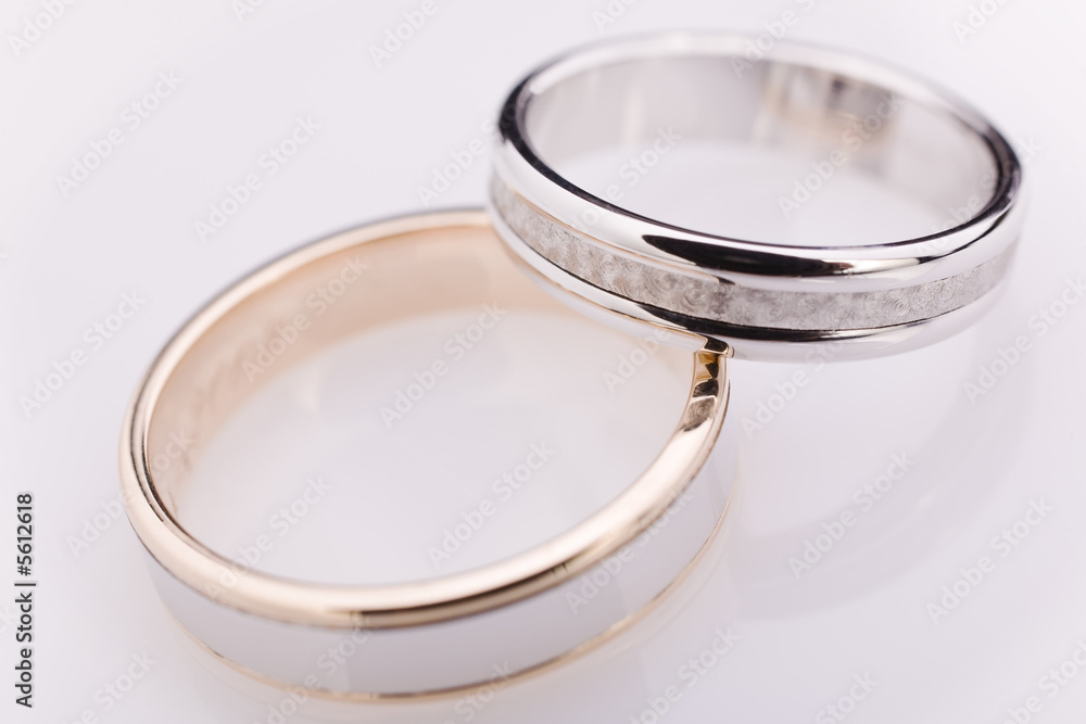 Two white gold engagement rings over a white Two white gold engagement rings over a white