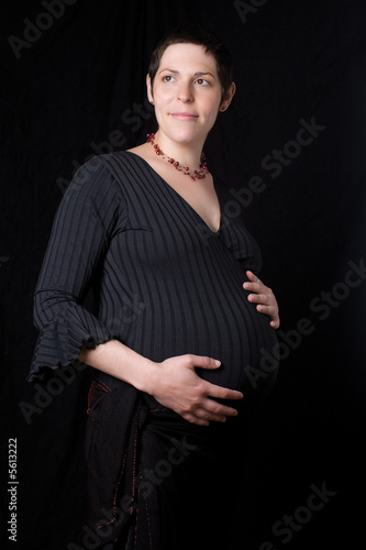 Late twentie pregnant woment looking to the far right photo