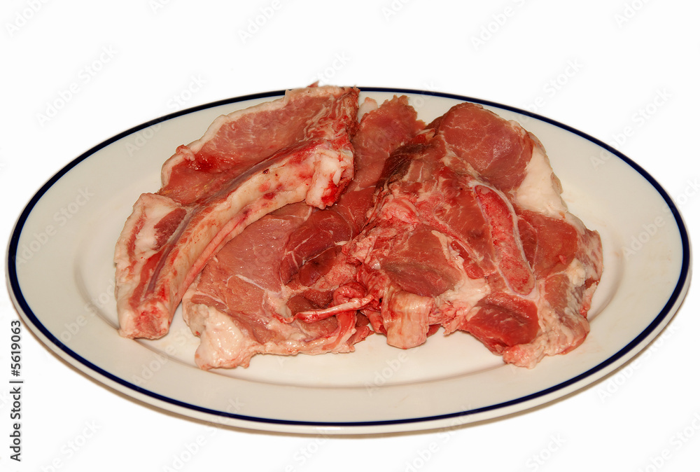fresh red meat chops in white porcelain dish
