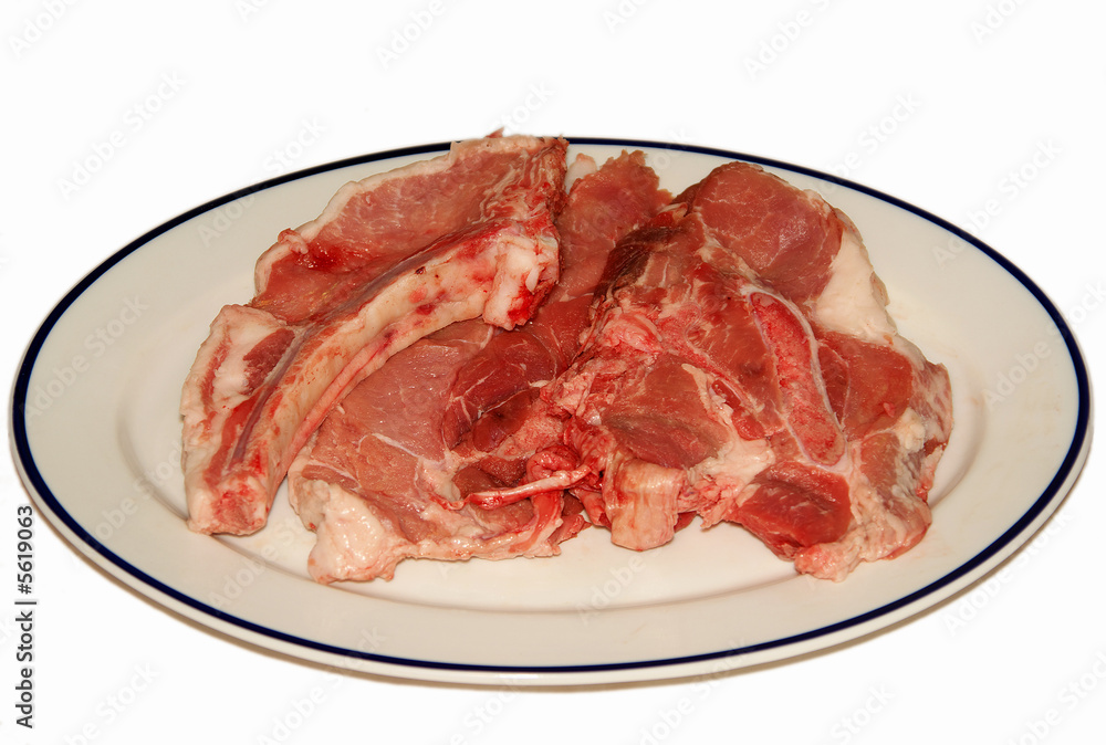 fresh red meat chops in white porcelain dish fresh red meat chops in white porcelain dish