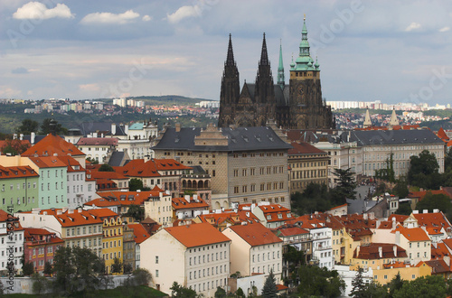 Castle and buildings with red roofs of Prague city, Czechia