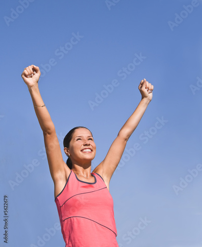 Happy young woman expressing the joy of winning.