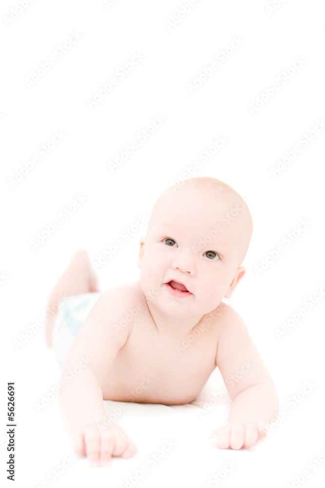 Funny little baby lying on white bed over white background Funny little baby lying on white bed over white background