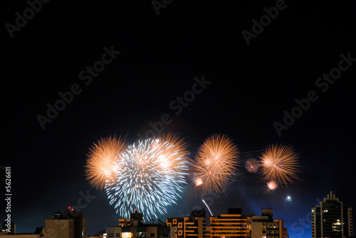 Fireworks behind the buildingsin the city . photo