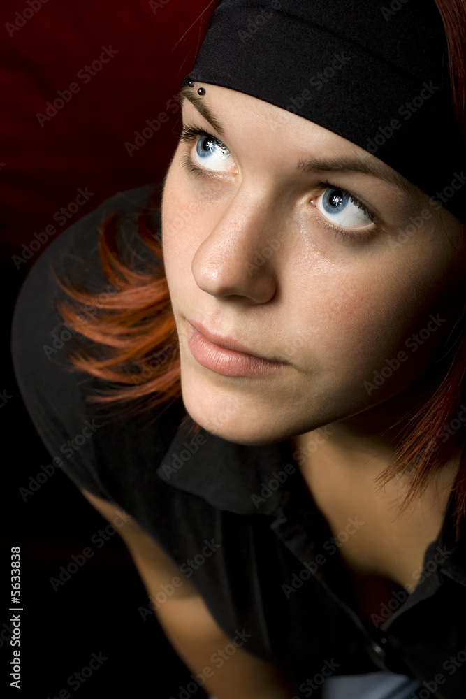 Cute redhead looking up and thinking.