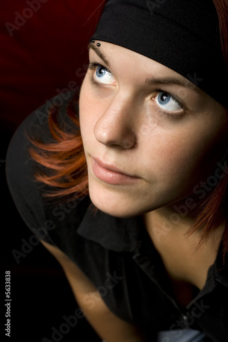Cute redhead looking up and thinking.