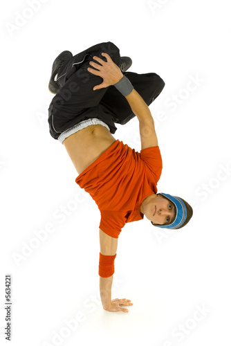 Young bboy standing on one hand. Holding legs in air.  photo