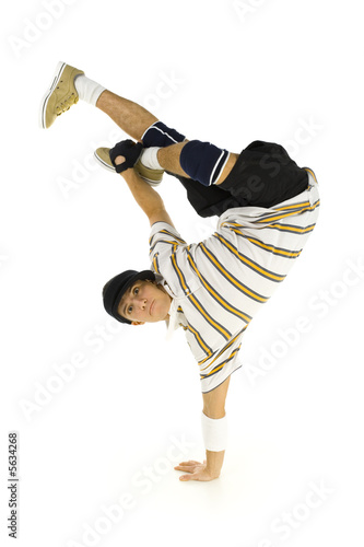 Young bboy standing on one hand. Holding legs in air.  photo