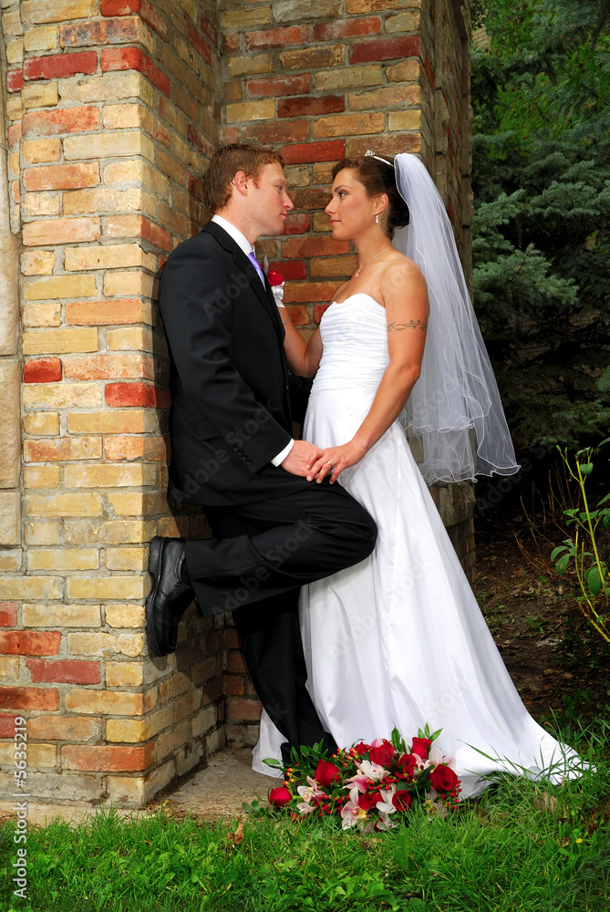 A bride and groom look at each other with love A bride and groom look at each other with love