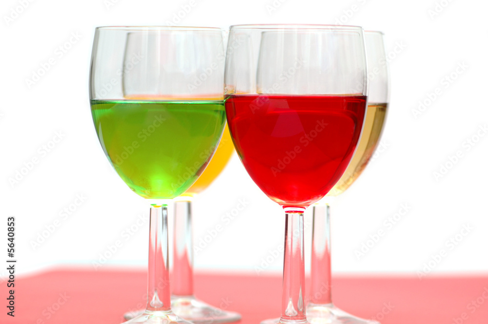Glasses with drinks of various colours on white