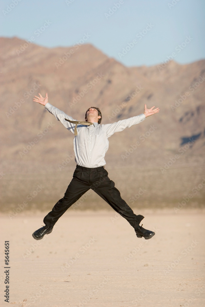 Happy businessman jumping in air Happy businessman jumping in air