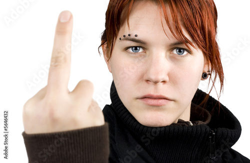 Angry redhead girl showing middle finger.