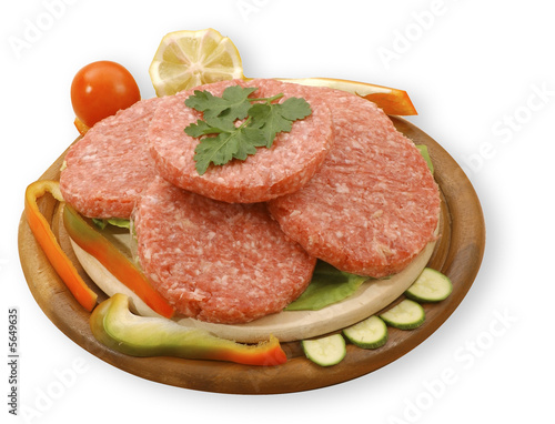 four raw hamburgers, isolated, with clipping path