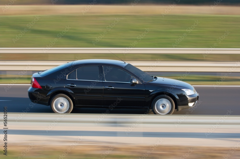 Car going fast on the highway with motion blur