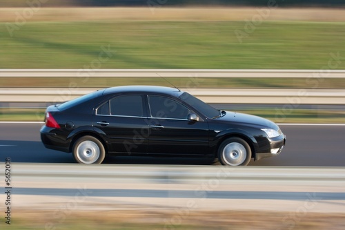 Car going fast on the highway with motion blur © Gudellaphoto