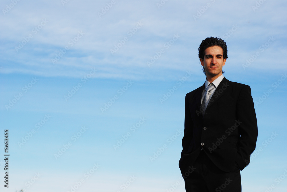 confident and successful businessman is posing against the sky confident and successful businessman is posing against the sky