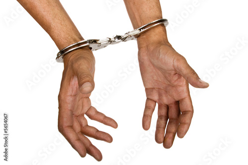 Billede på lærred Man hands with handcuffs top view