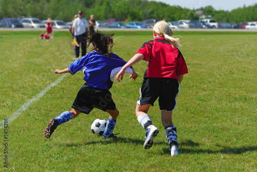 Two youth soccer players in action