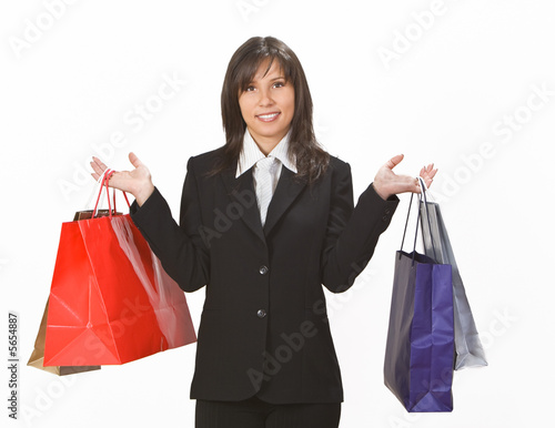 Image of a smiling brunette with shopping bags.