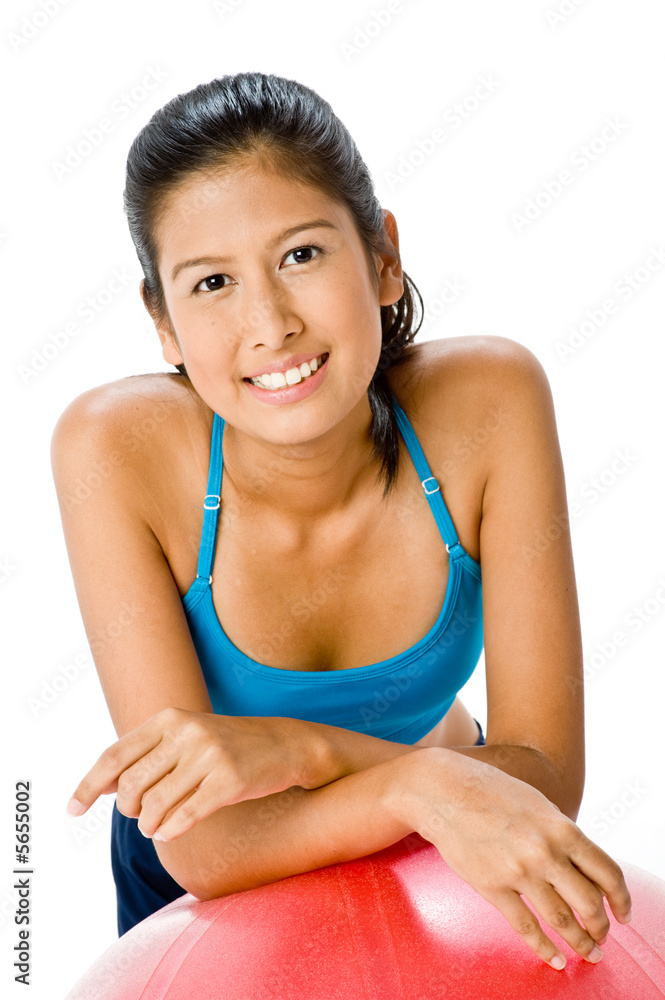 An attractive young Asian woman resting on fitball An attractive young Asian woman resting on fitball