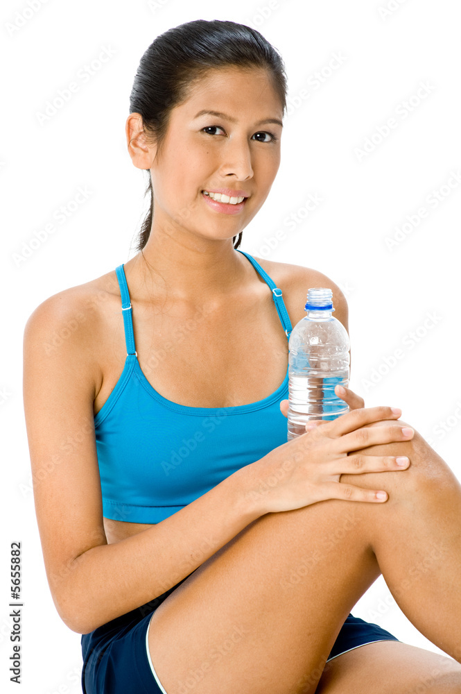 An attractive young Asian woman with water bottle An attractive young Asian woman with water bottle