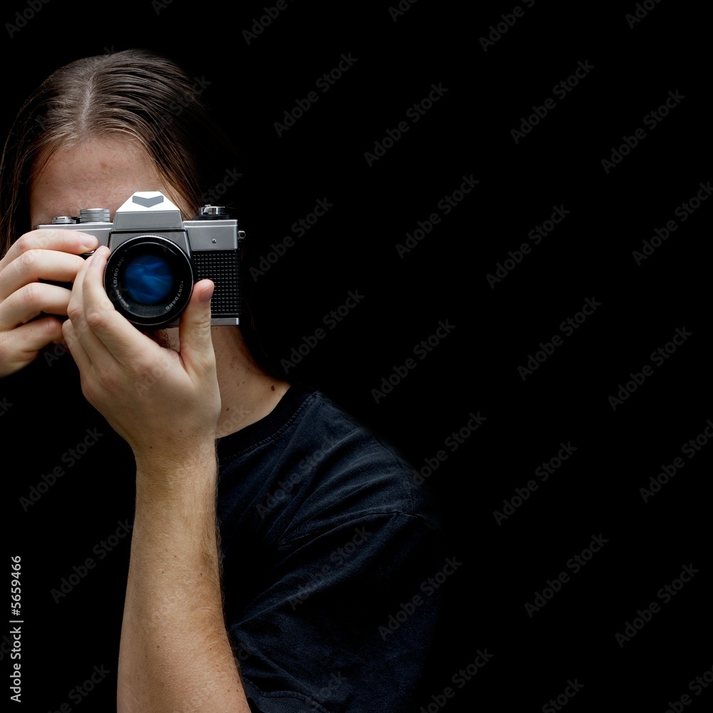 Photographer with an old film camera isolated on black Photographer with an old film camera isolated on black