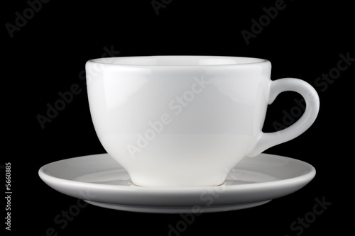 White cup and saucer isolated against black background