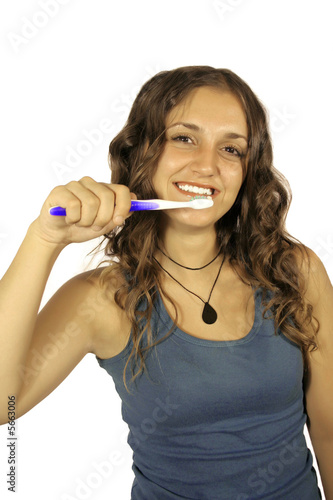 beautiful brunette cleaning her teeth