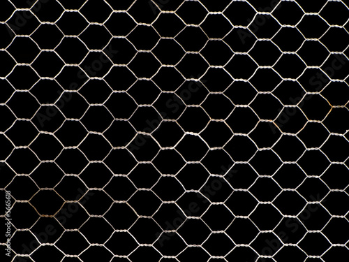 Old, rusty metal net isolated on black