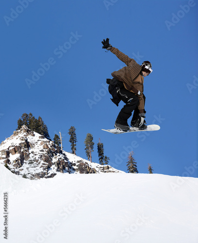 Snowboarder jumping high at Lake Tahoe resort
