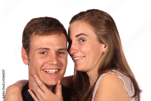 Girl whispering into her boyfriend's ear isolated