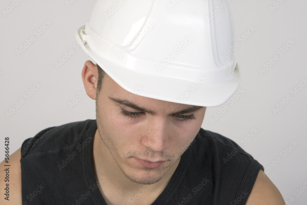 Closeup portrait of a young, handsome man in a hardhat Closeup portrait of a young, handsome man in a hardhat