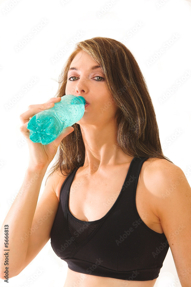Middle aged lady drinking a bottle of sparkling water Middle aged lady drinking a bottle of sparkling water