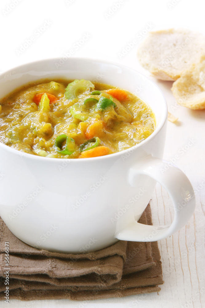Chunky vegetable soup in white soup cup. Chunky vegetable soup in white soup cup.