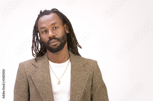 A black man with dreadlock hair isolated on a white background.