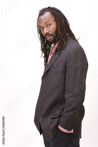 A black man with dreadlock hair isolated on a white background.