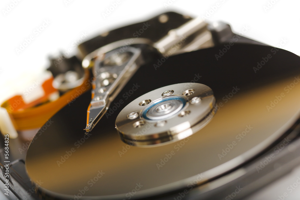 Modern opened hard disk drive over a white surface Modern opened hard disk drive over a white surface