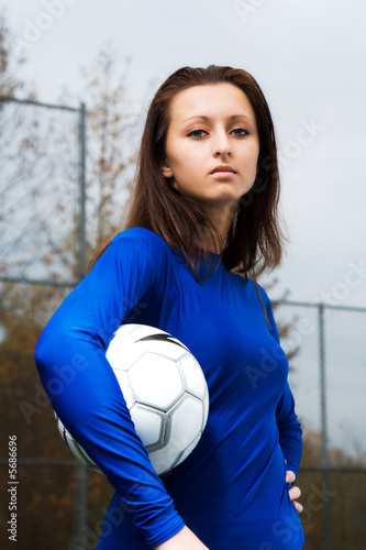 A shot of a soccer player carrying a soccer ball
