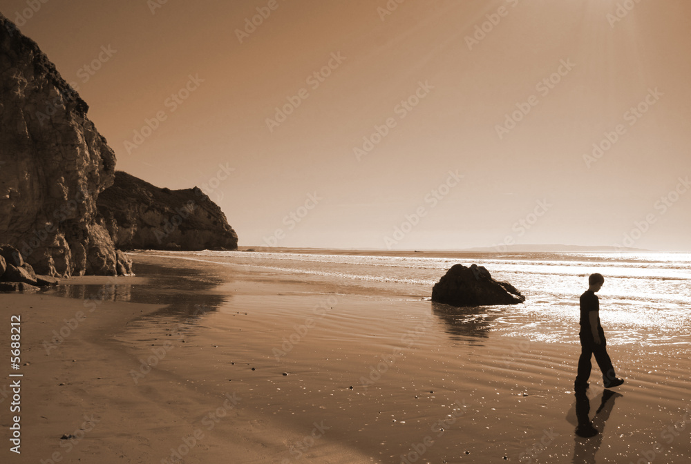 Young boy on a isolated beach on the California coast.