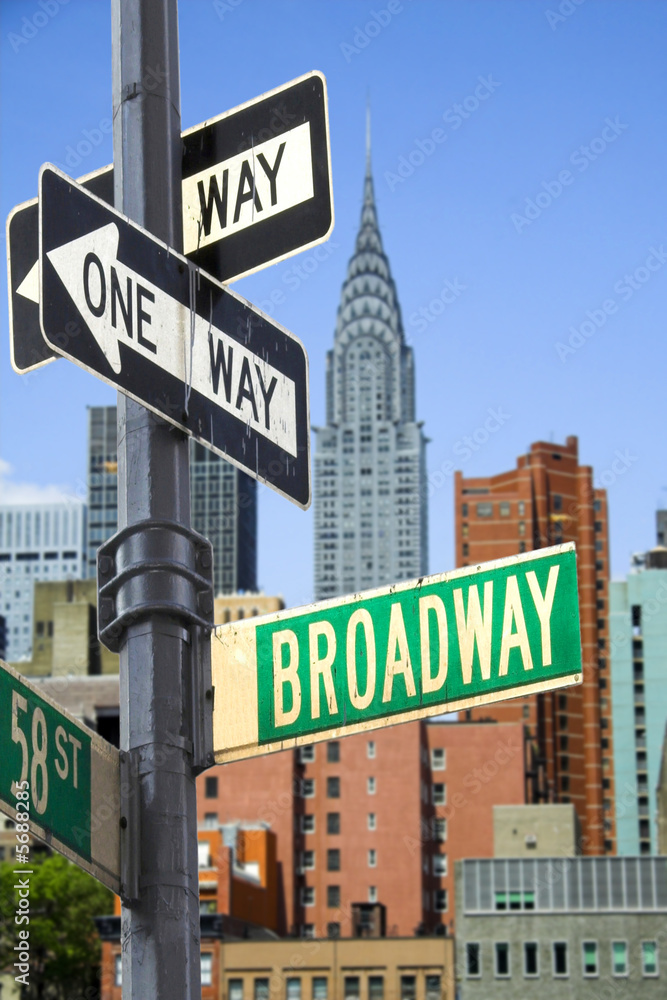 Broadway sign in front of New York City skyline